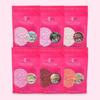Six colorful packets of sprinkles arranged in two rows.