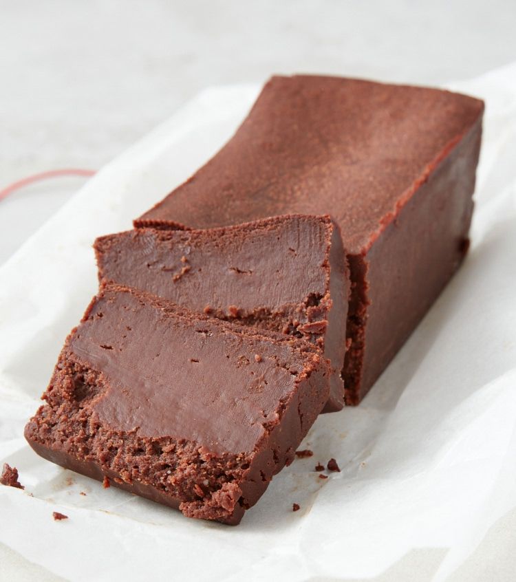 A sliced chocolate dessert on parchment paper.
