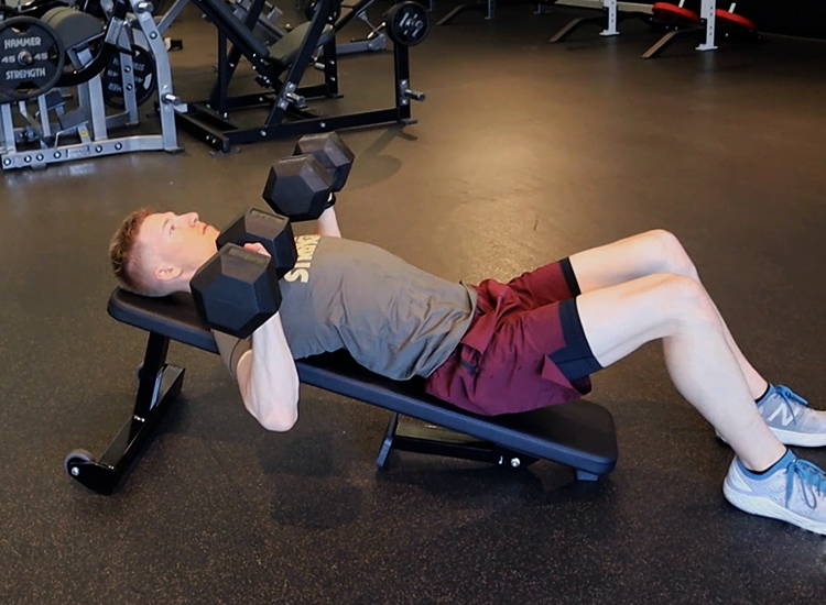 Exercise dumbbell pressing on angled bench