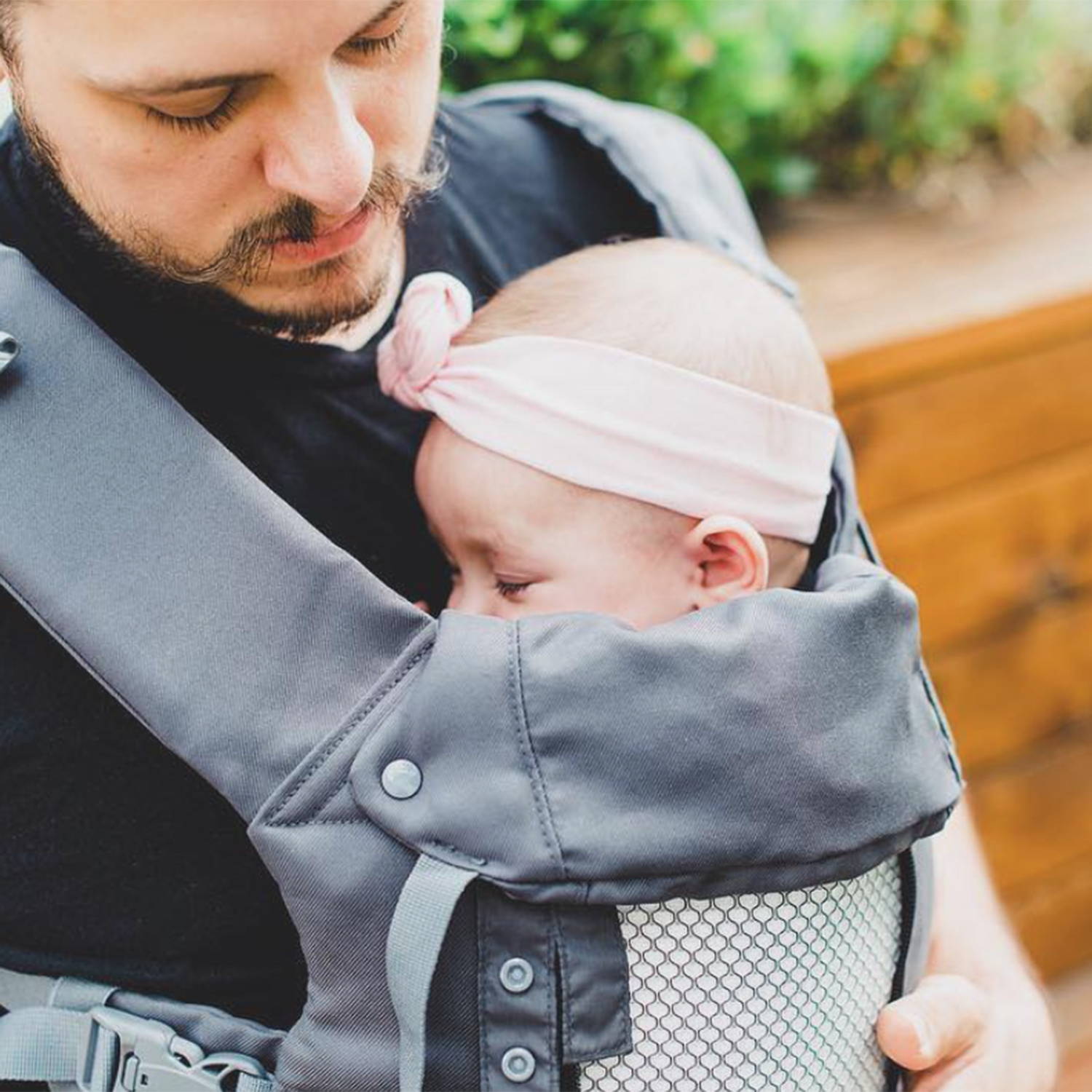 Baby asleep with dad in dark grey baby carrier - Best Baby Carriers for Dads