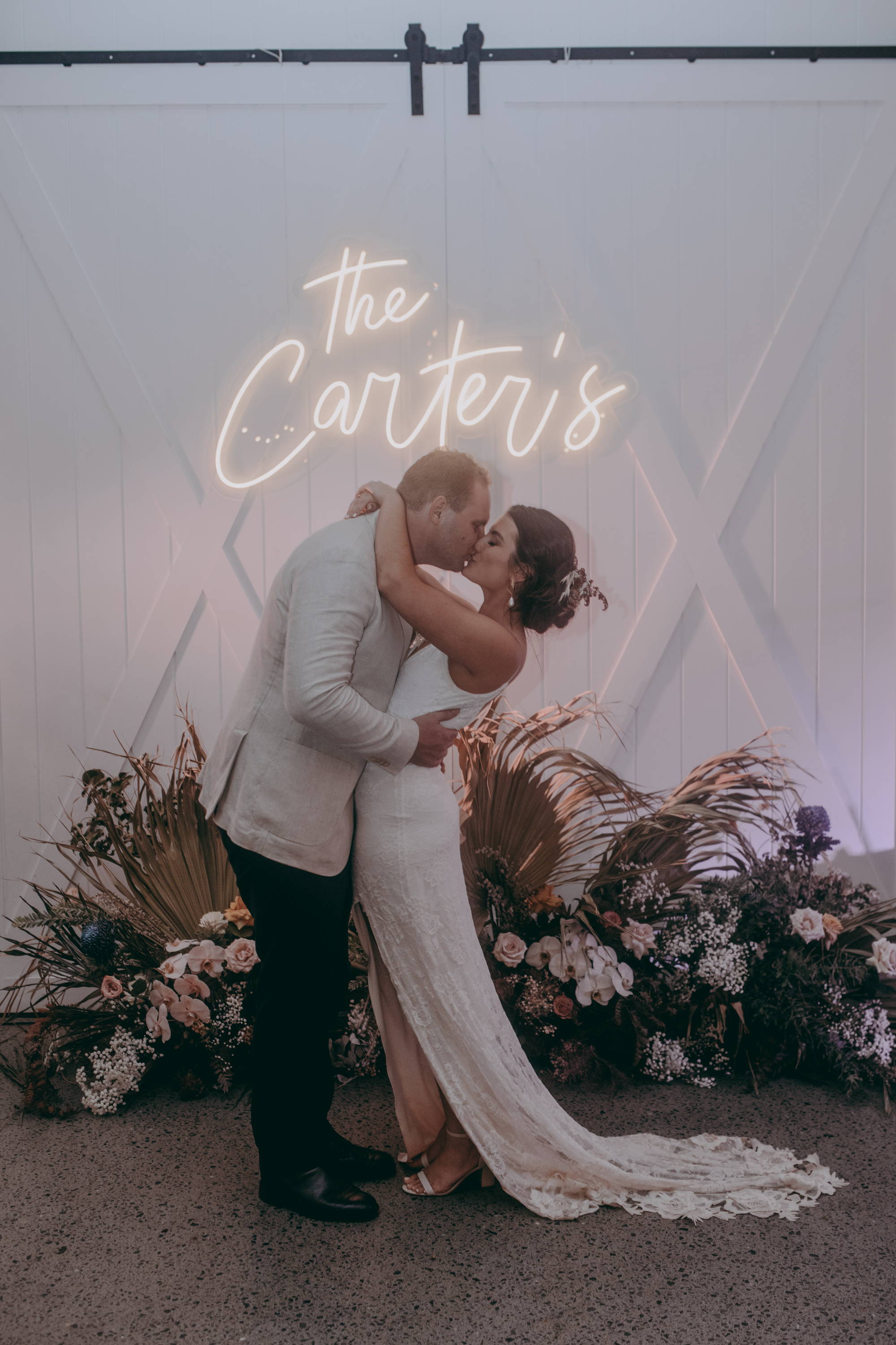 Bride wearing the Grace Loves Lace Lottie gown kissing her groom