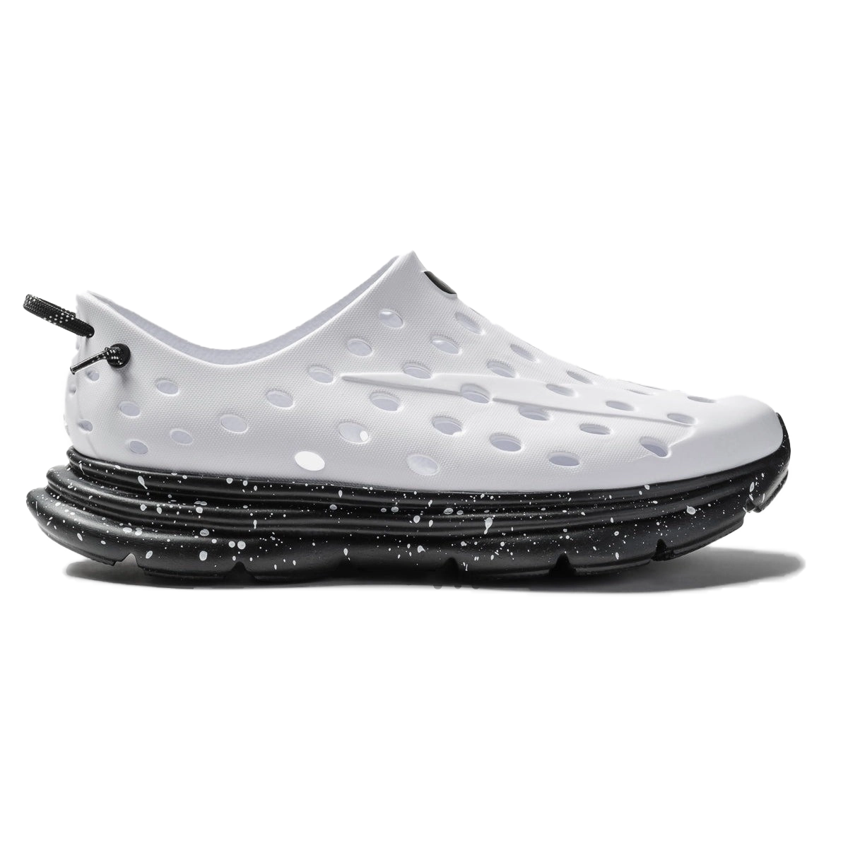White perforated slip-on shoe with a black speckled sole.