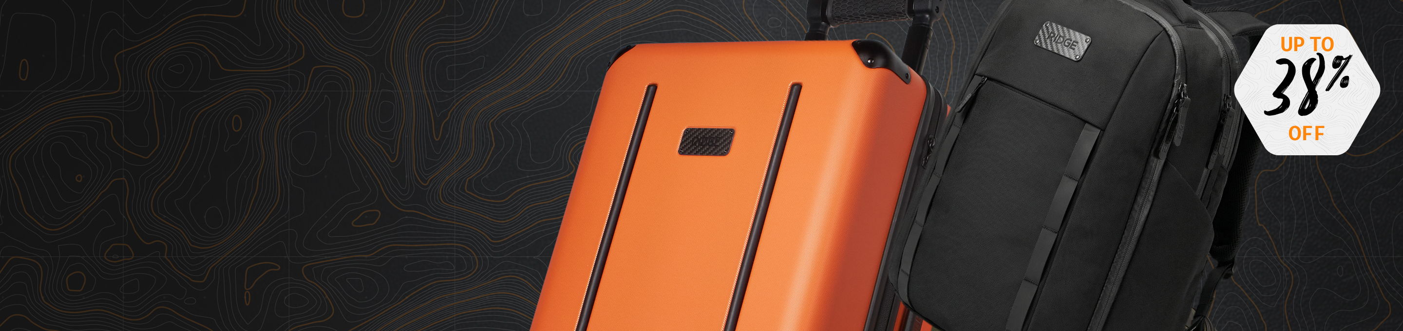 Orange and black luggage against a dark background.
