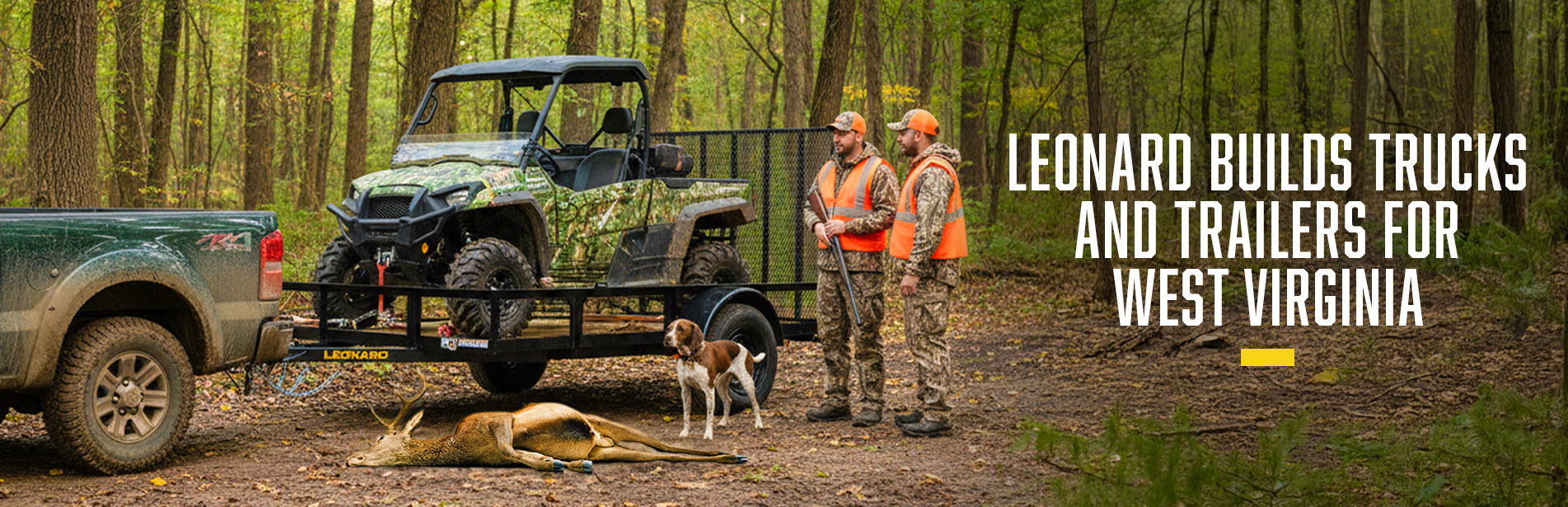 Two people and dogs beside a truck and trailer in a forest.
