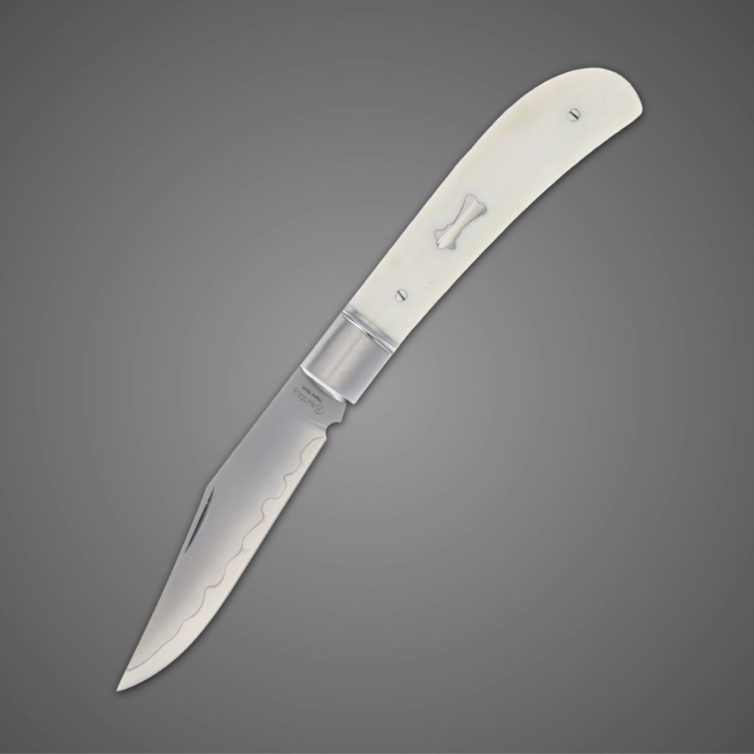 A folding knife with a silver blade and a white handle.