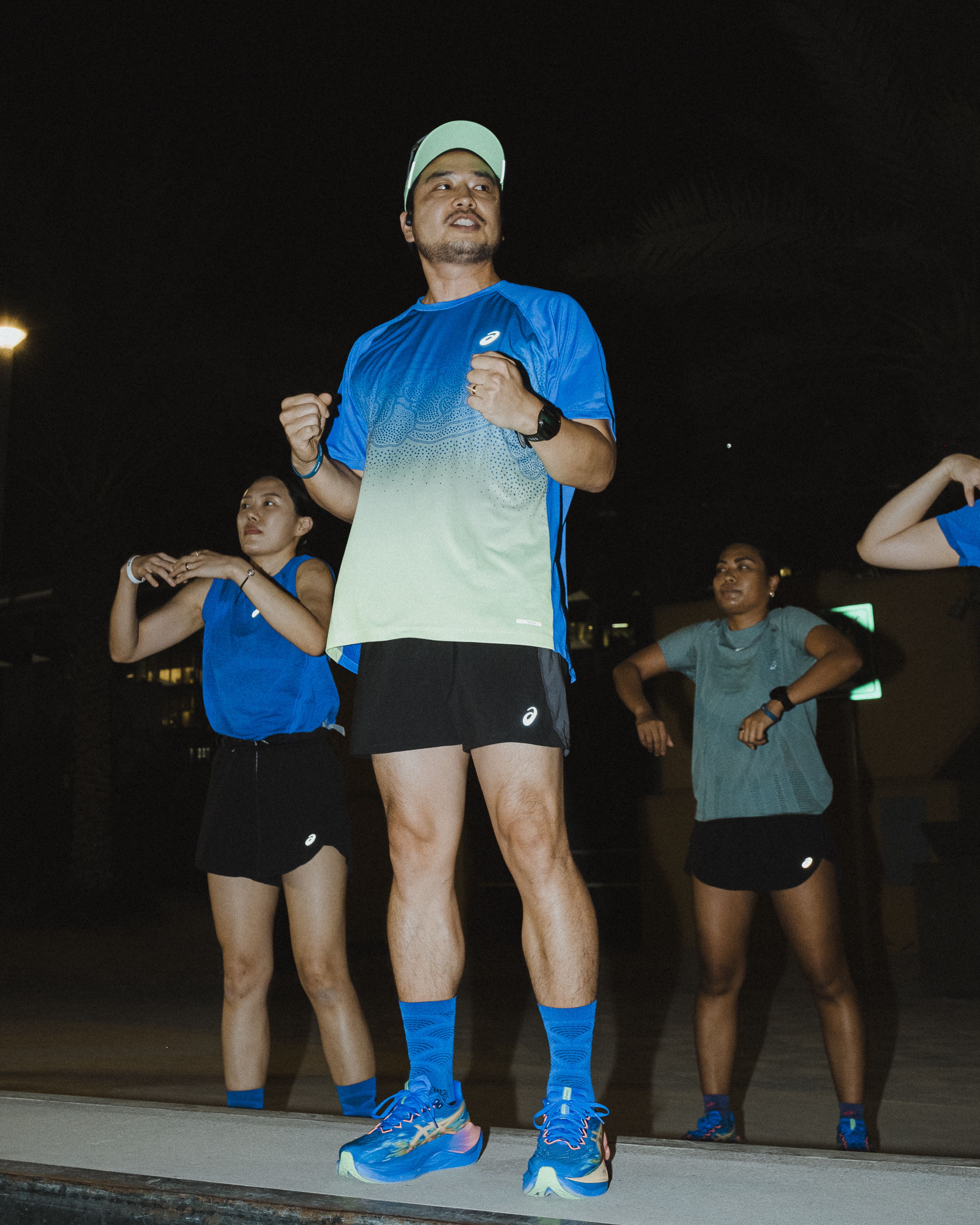 Therafit coaches leading the warm-up and stretching session for runners during Global Running Day with ASICS and FRAME RUN CLUB in Dubai.