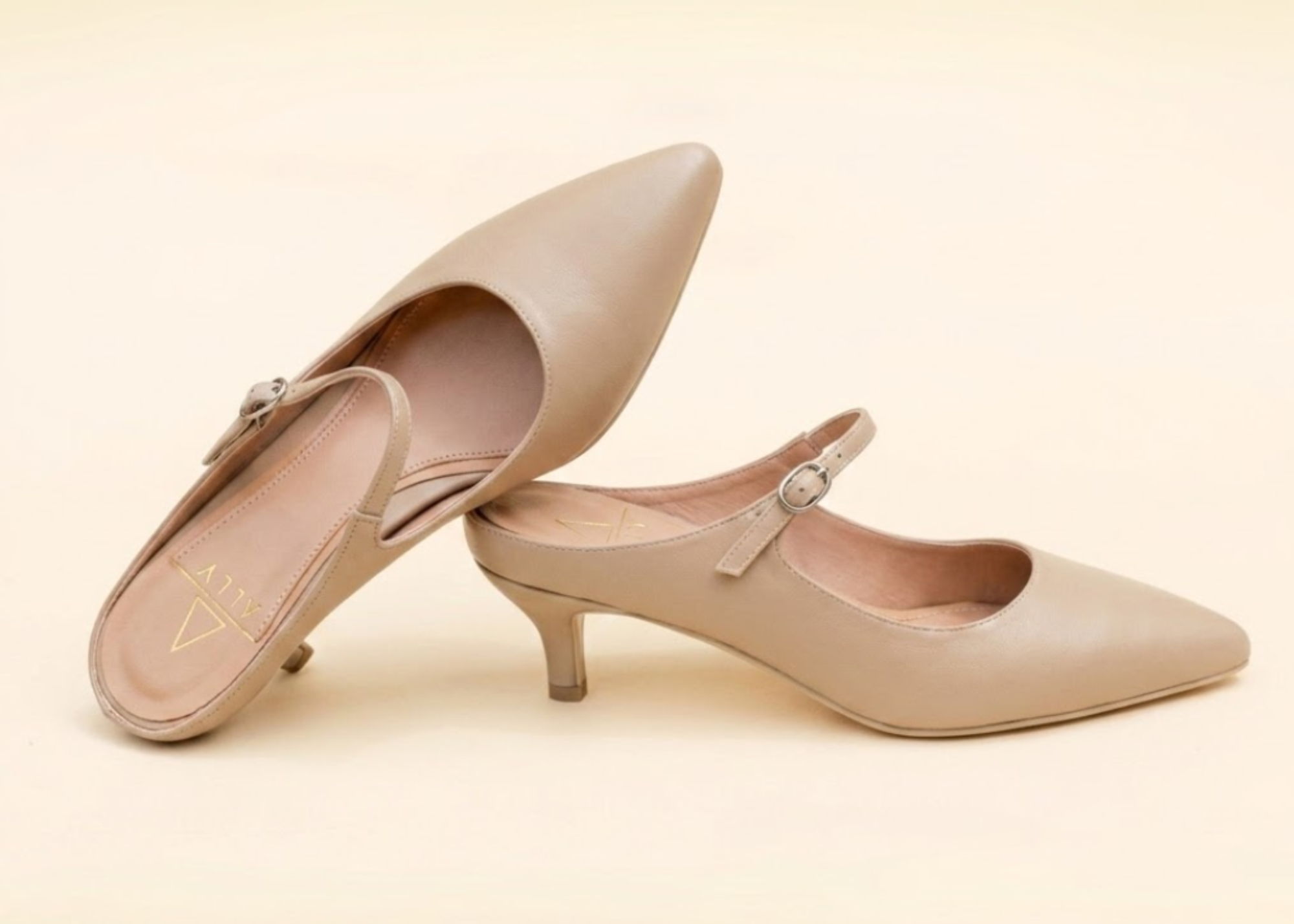 Beige slingback high-heel shoe with a strap and pointed toe.
