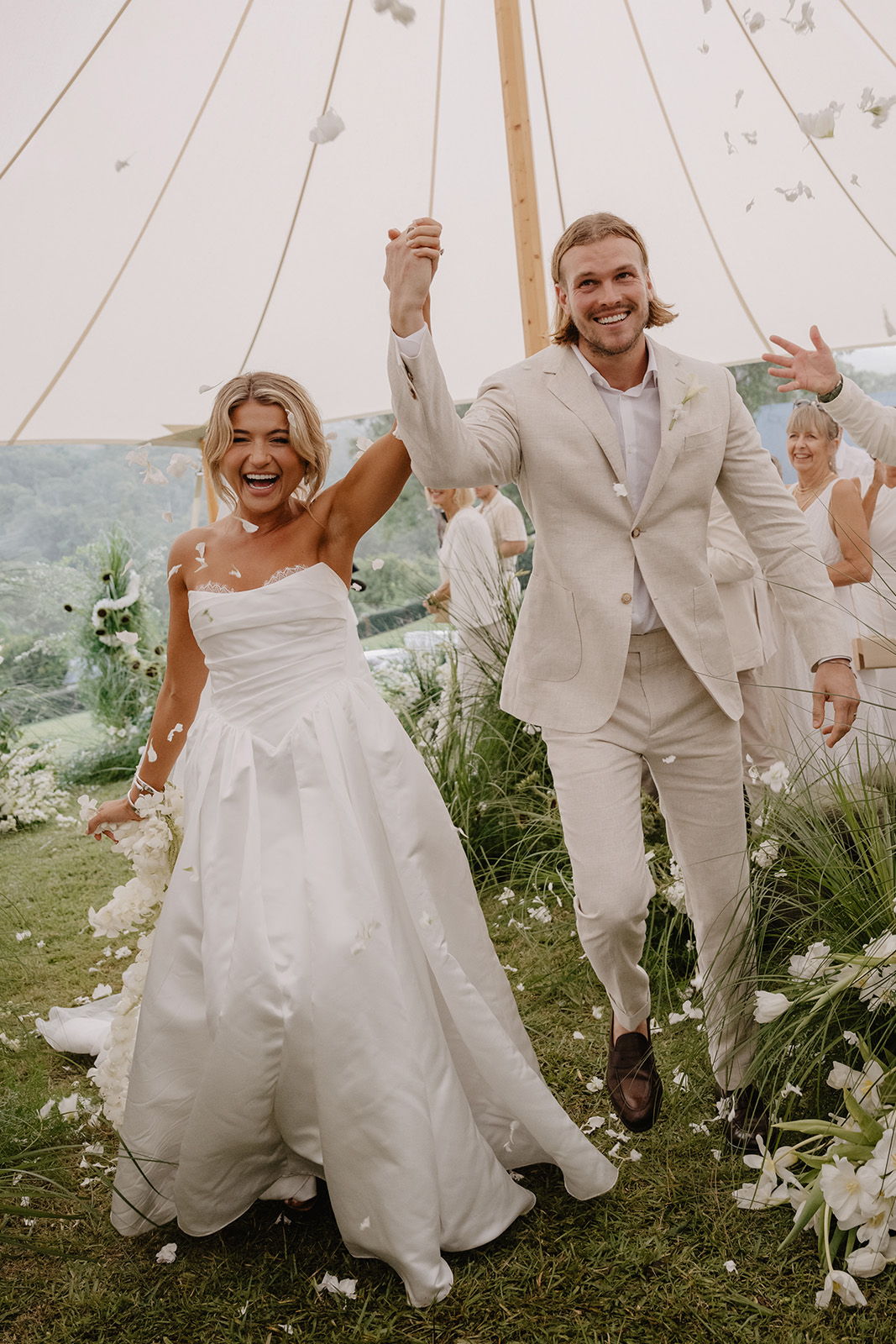 Bride and groom celebrating walking down the aisle