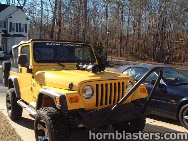 Front-three-quarter Eric's 2006 Jeep Wrangler exterior grille round headlights bumper Shocker XL train horn featured install photo 1