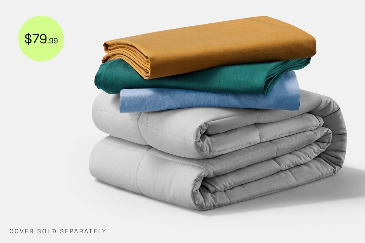 A folded stack of a Gravity Basics Weighted Blanket and three Gravity Basics Duvet Covers with a green disc reading $79.99