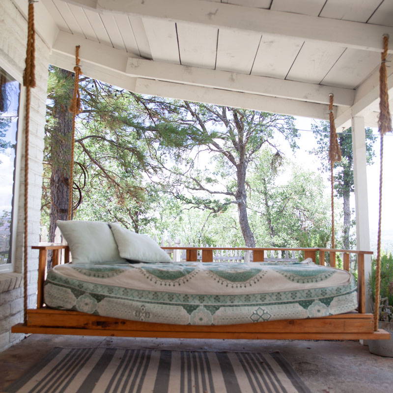 Swinging daybed on front porch of the AirBnB rental.