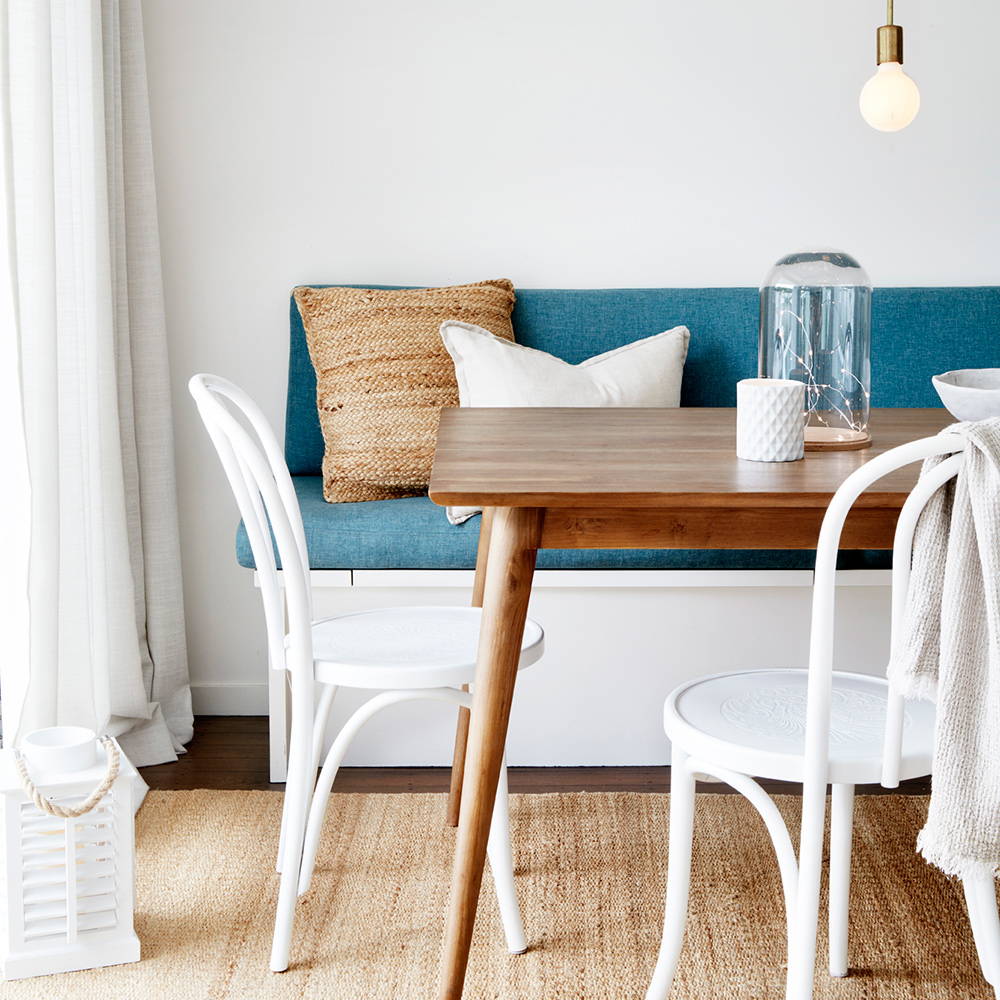 Micro lights in bell jar on dining table and lantern on the floor.