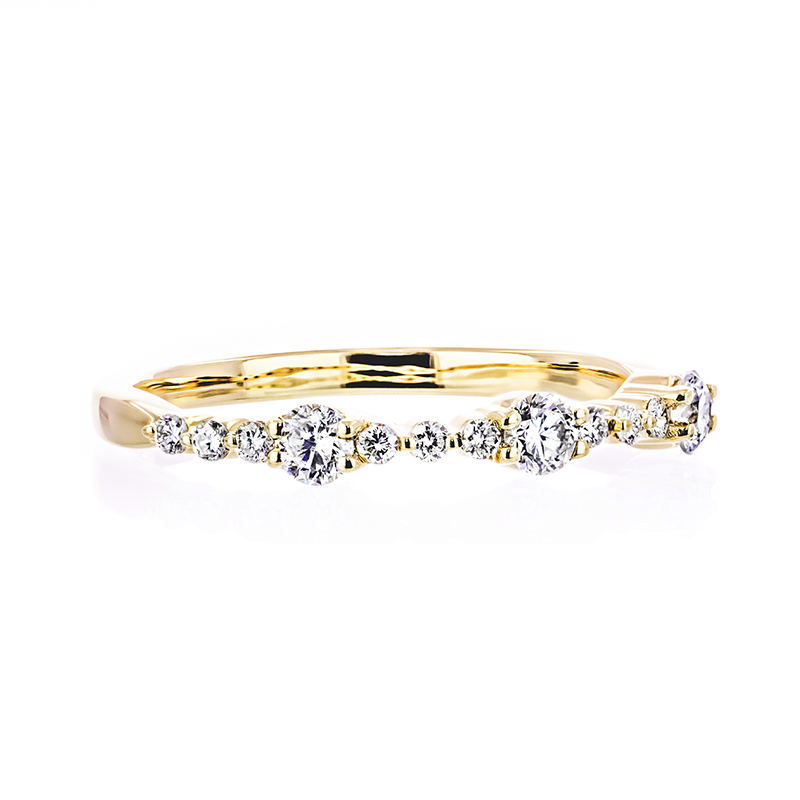 gold multi-stone diamond ring with a dainty elegant design and diamonds covering around one third of the band