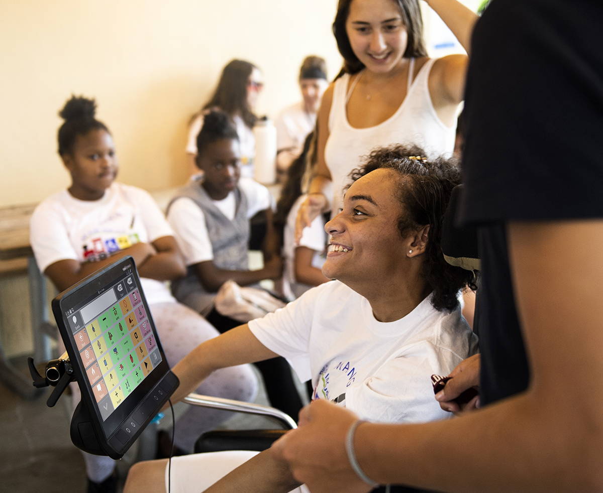 Young girl using Tobii Dynavox TD I-13 device with TD Snap 