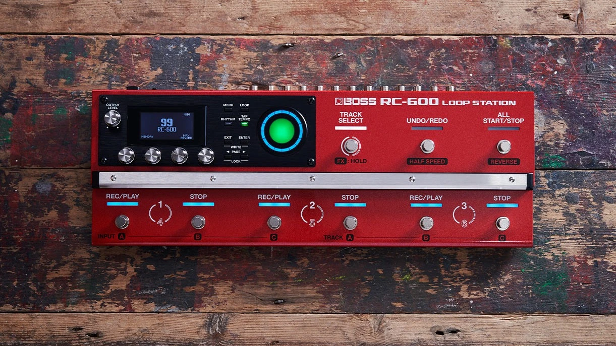 Red guitar effects pedal on a wooden surface.