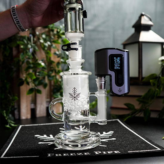 A Freeze Pipe glass dab rig with an e-nail