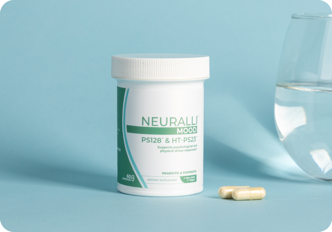 Container of Neuralle 1000 capsules next to a glass of water.