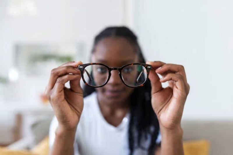 Woman holding Fierce Black prescription glasses