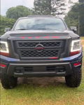 Front view Jonathan's 2020 Nissan Titan dark blue PRO-4X red TITAN hood lettering MEGATRON grille LED DRLs Outlaw 228H train horn kit featured customer install gallery photo 1