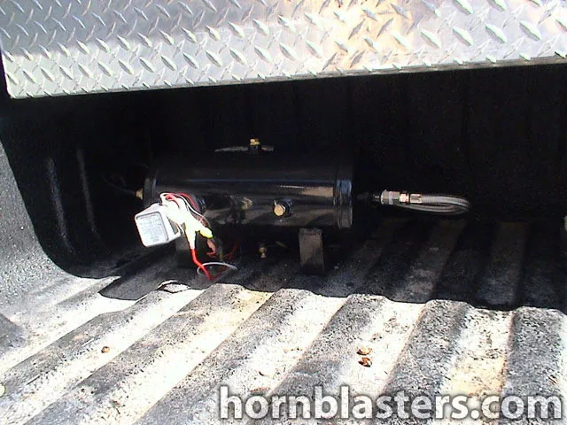 Black air tank mounted beneath truck bed toolbox