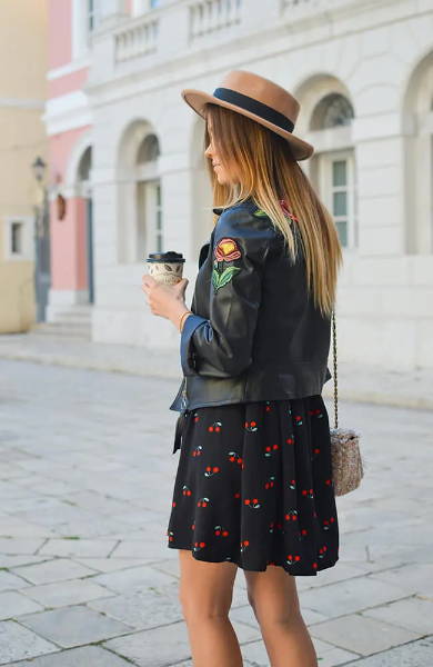 blonde balayage girl wearing a hat  and holding coffee cup