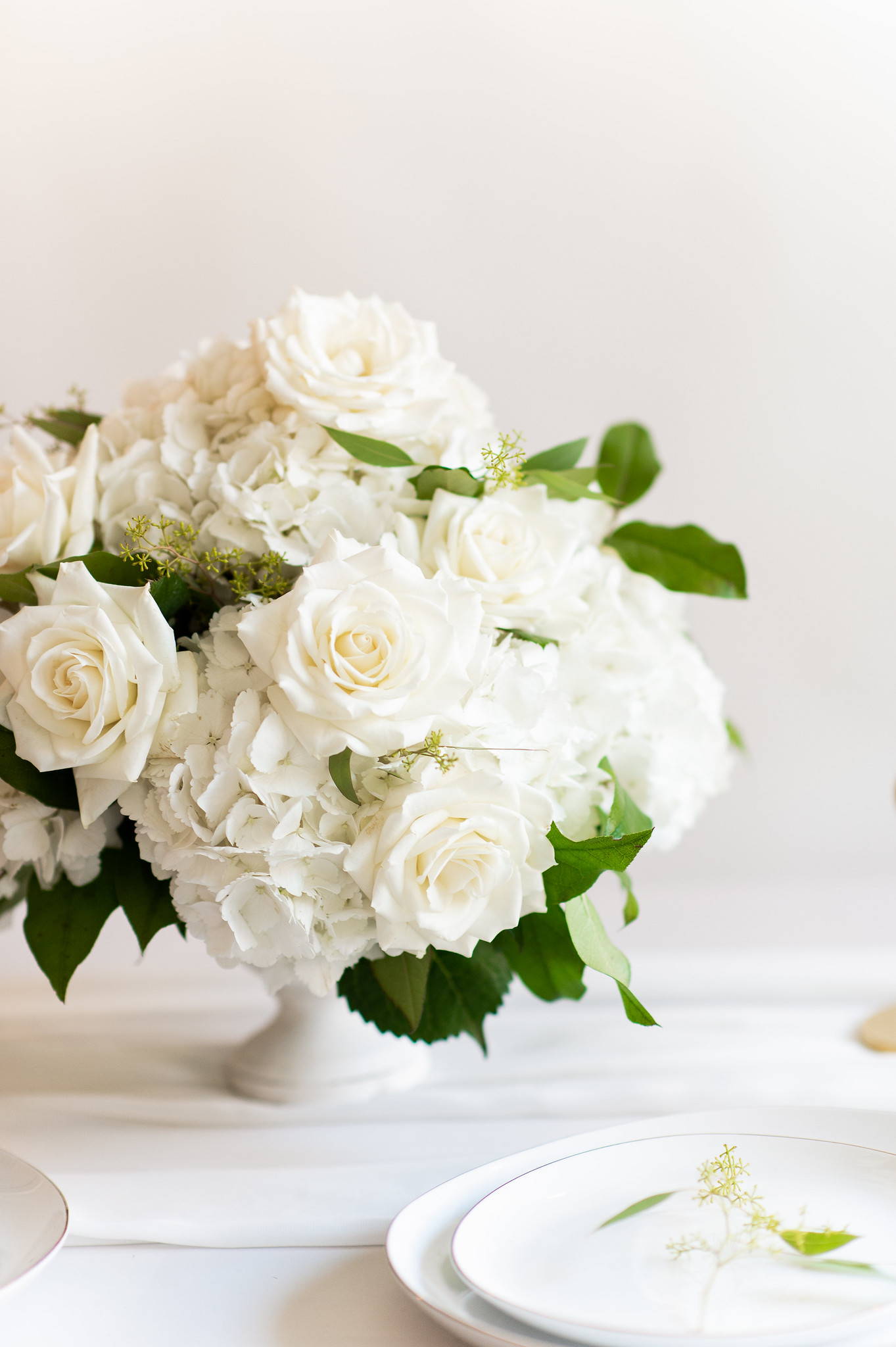 hydrangea and rose centerpiece white vase