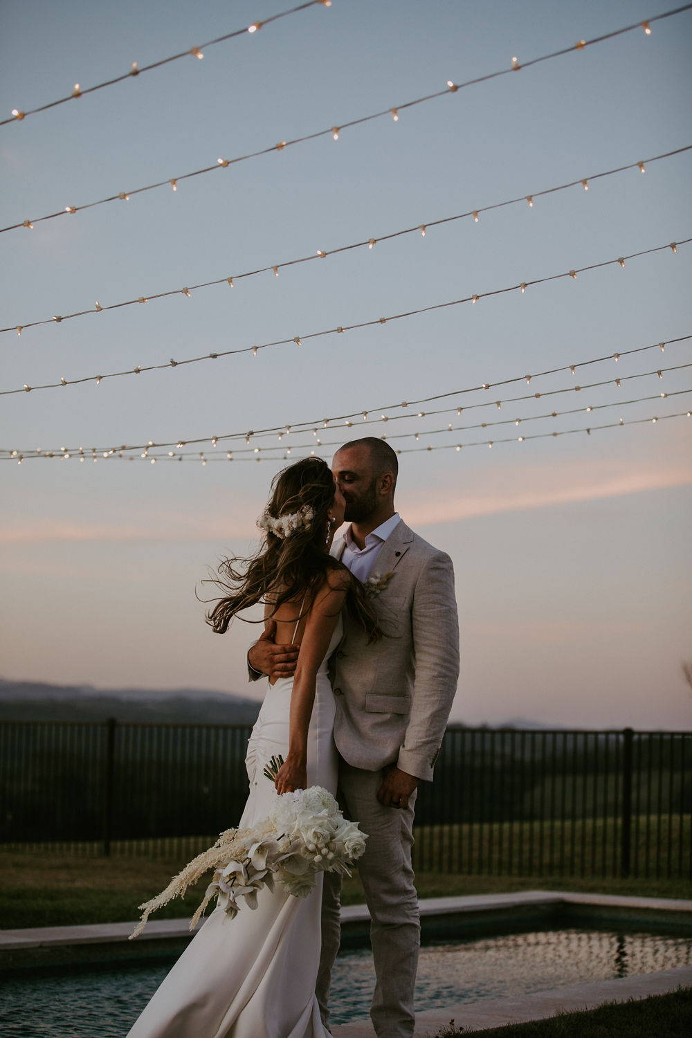 Grace Loves Lace bride wearing the Clo Crepe wedding dress kissing her groom