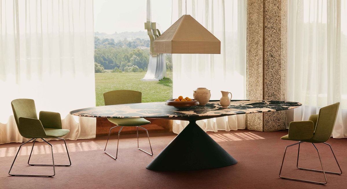 Modern dining room with a unique table, chairs, and large windows.