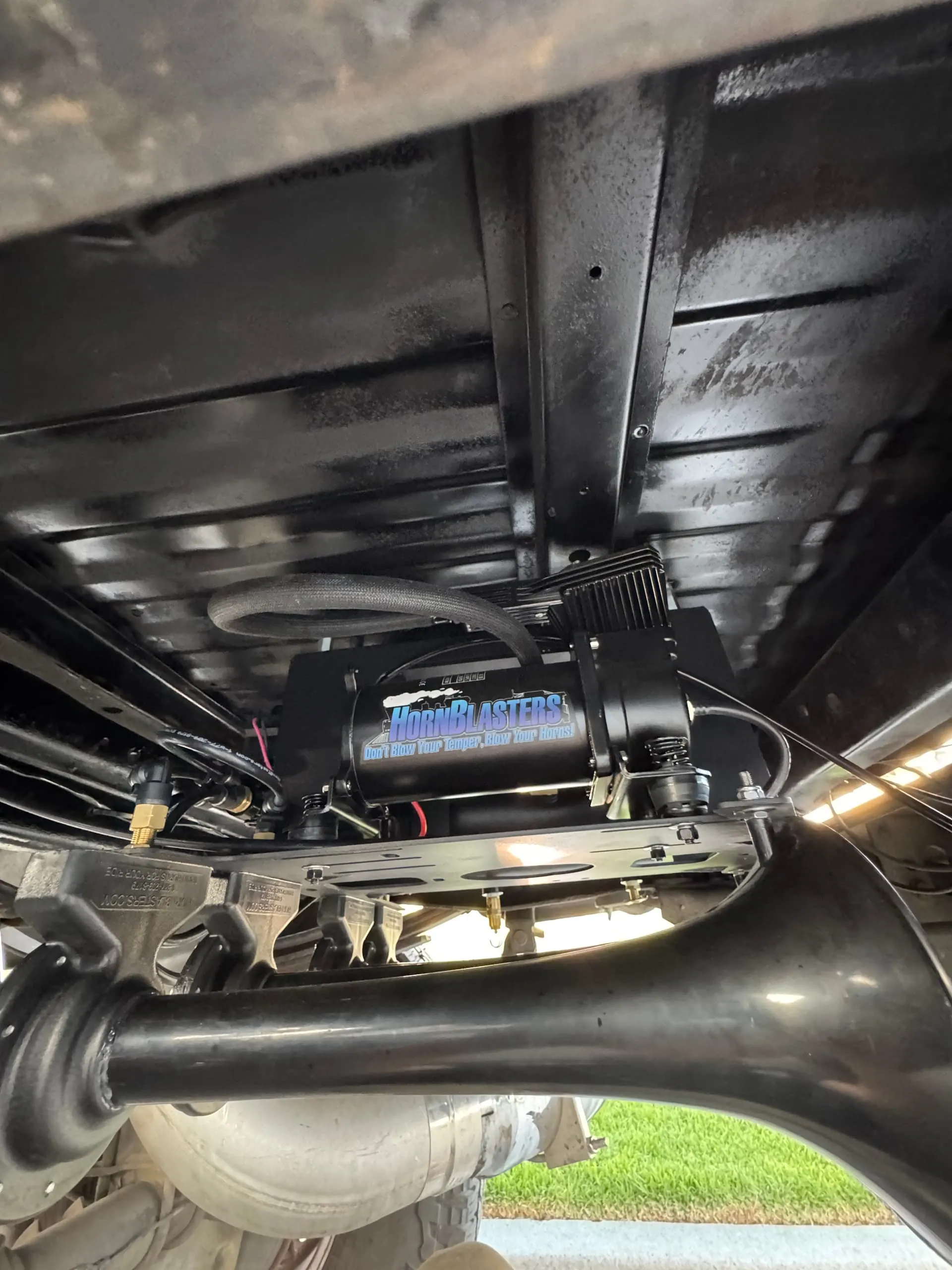 HornBlasters air compressor and train horns mounted under the bed of Noah's Ford F250