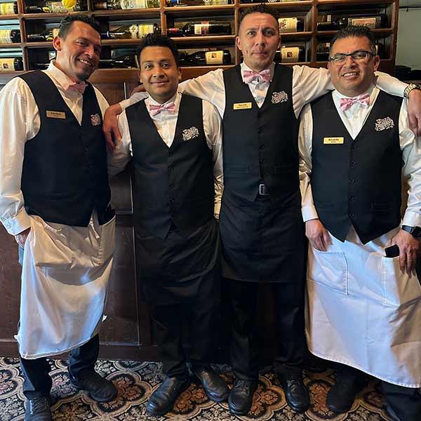 These waiters changed up their restaurant uniforms with carnation pink bow ties