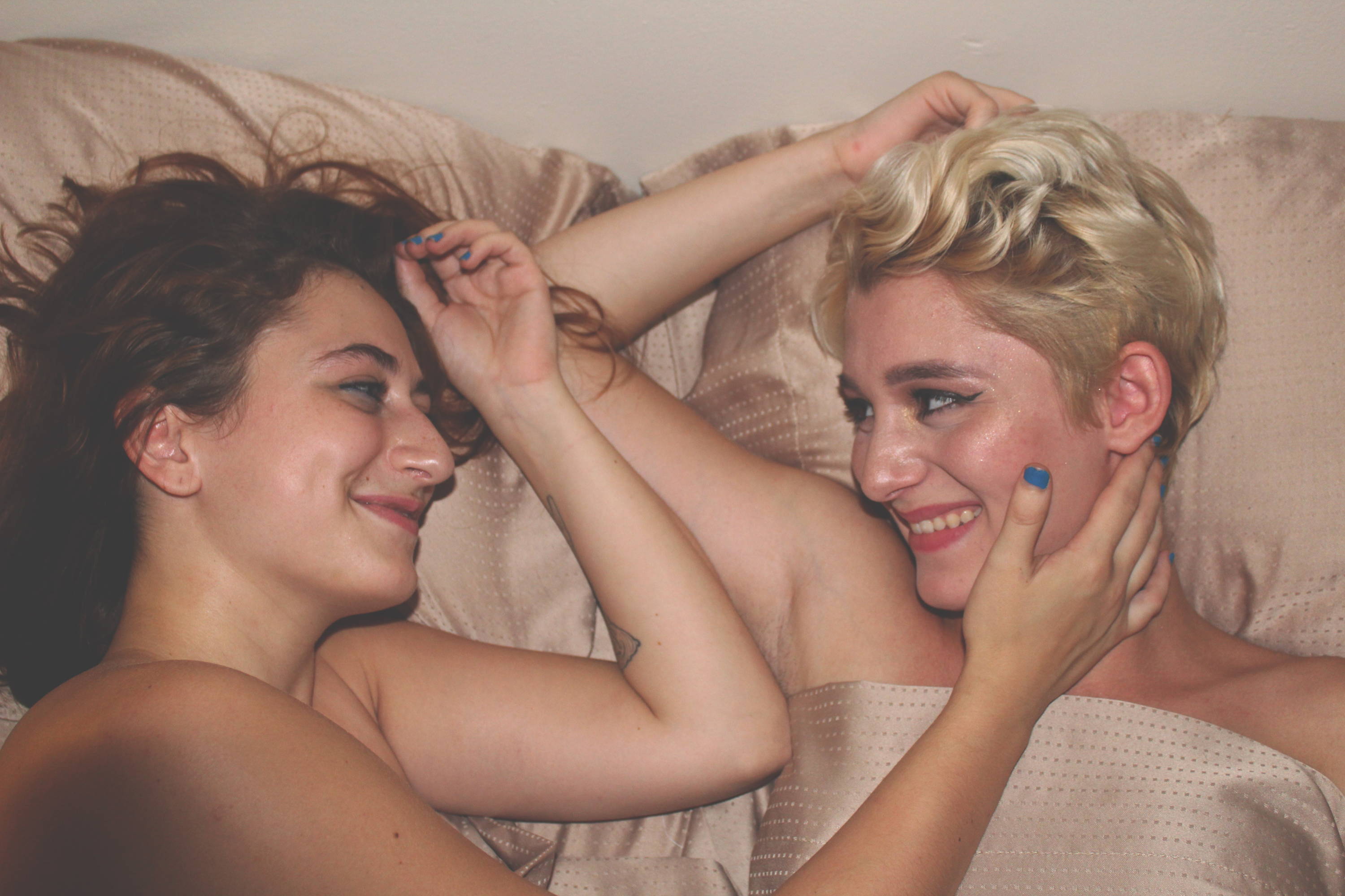 rem-fit is sleeping naked better.  two women in bed smiling