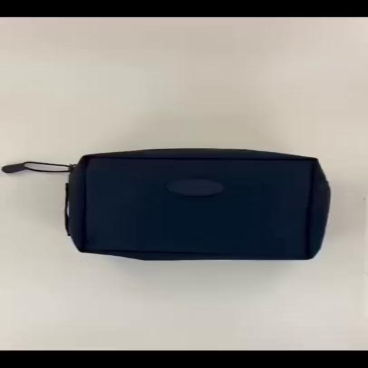 Black rectangular bag on a light surface.