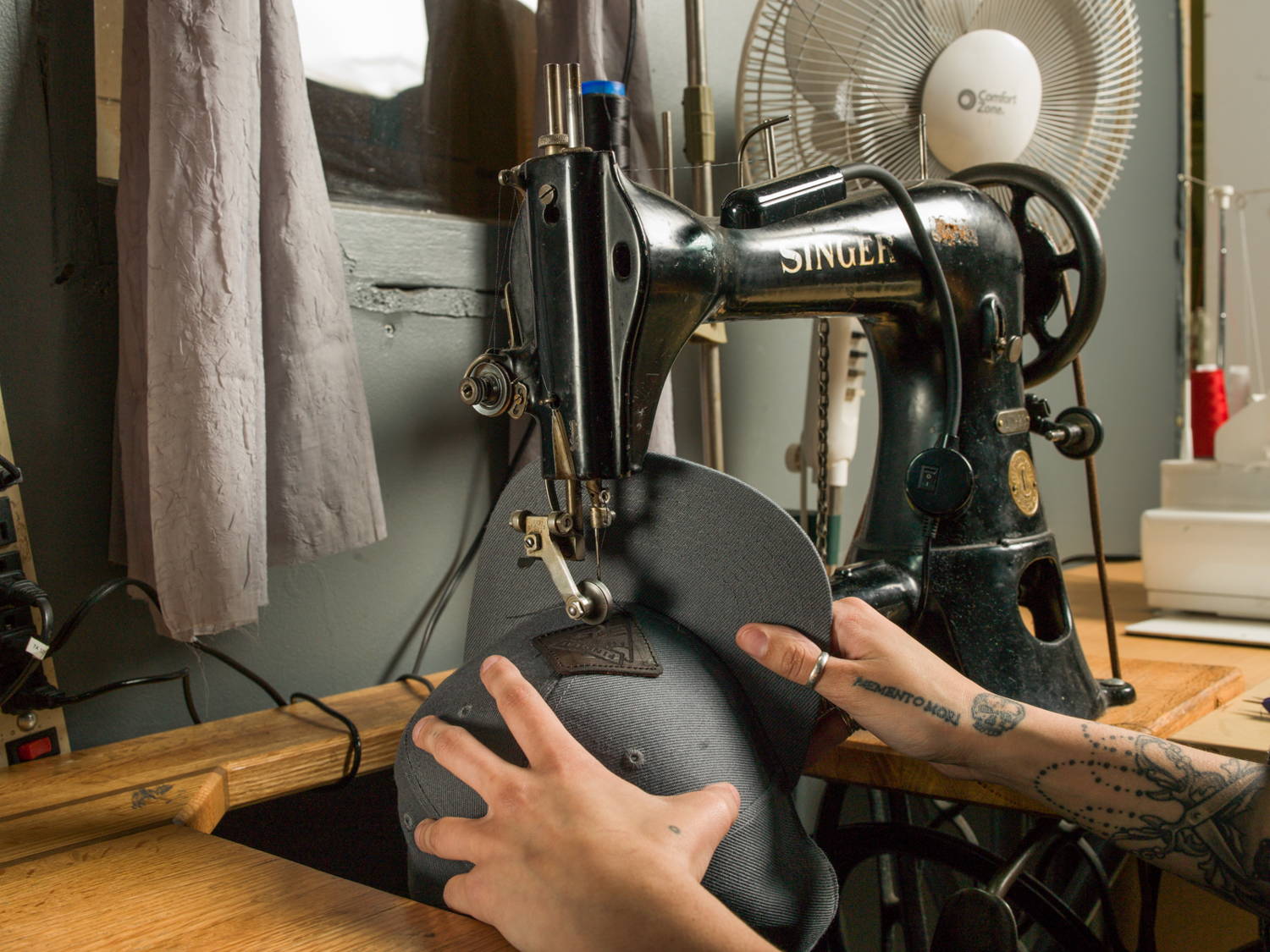 Sewing a Findlay hat at the machine.