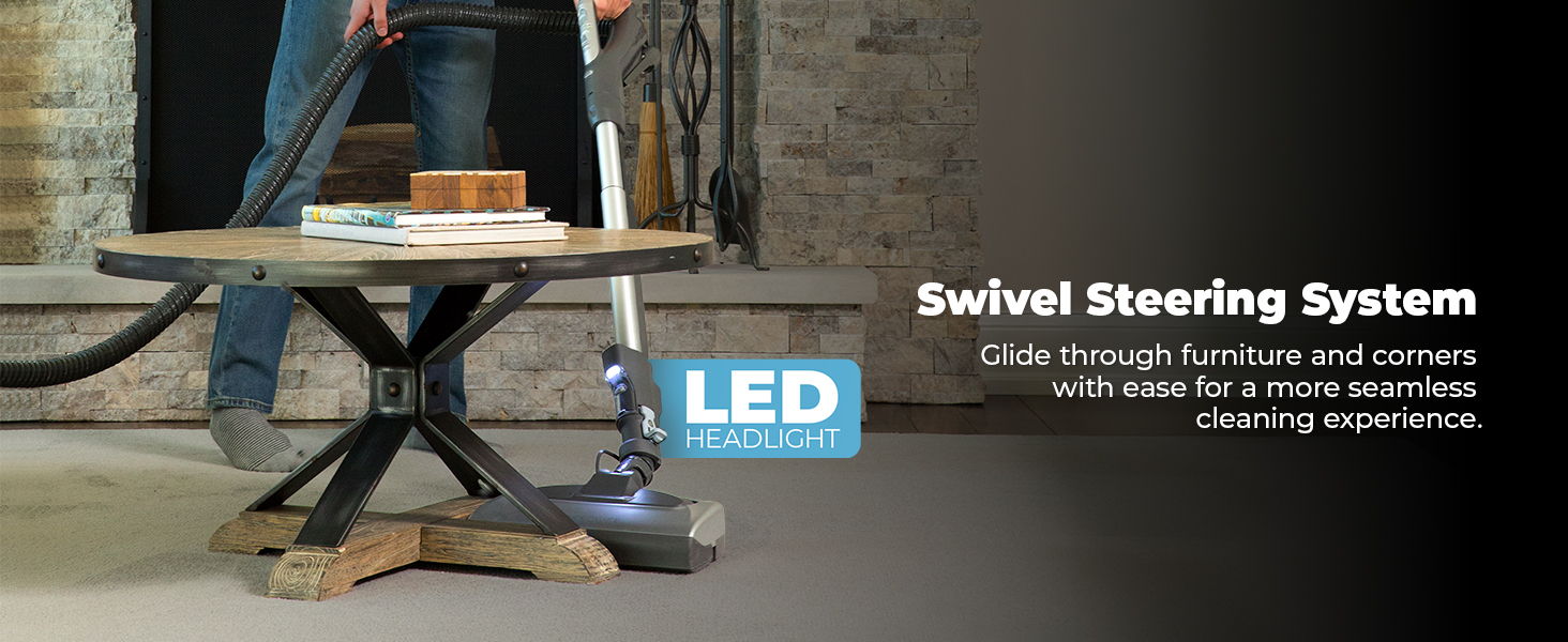 Vacuum cleaner demonstrating swivel steering and LED light features on a table.