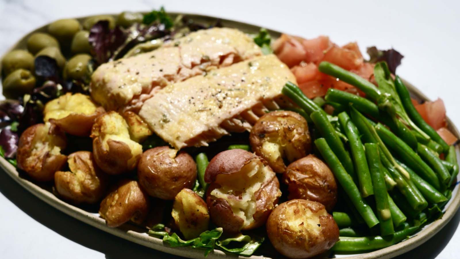 Gourmend recipe for low fodmap salon nicoise salad with roasted smashed potatoes & turmeric dressing