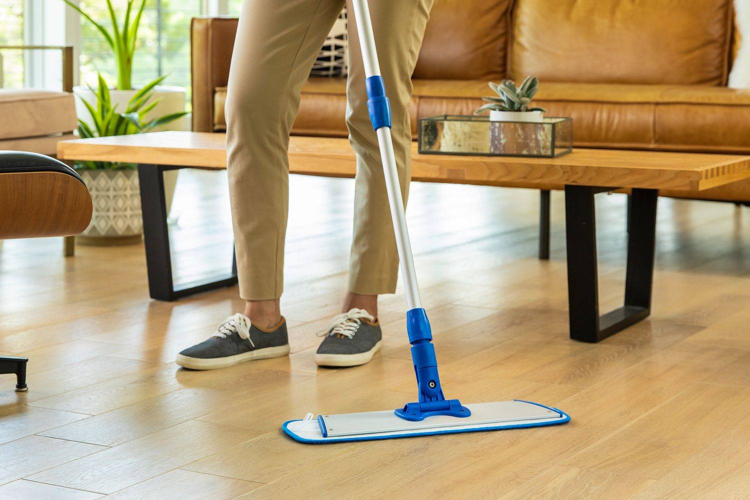 person cleaning floor using microfiber mop