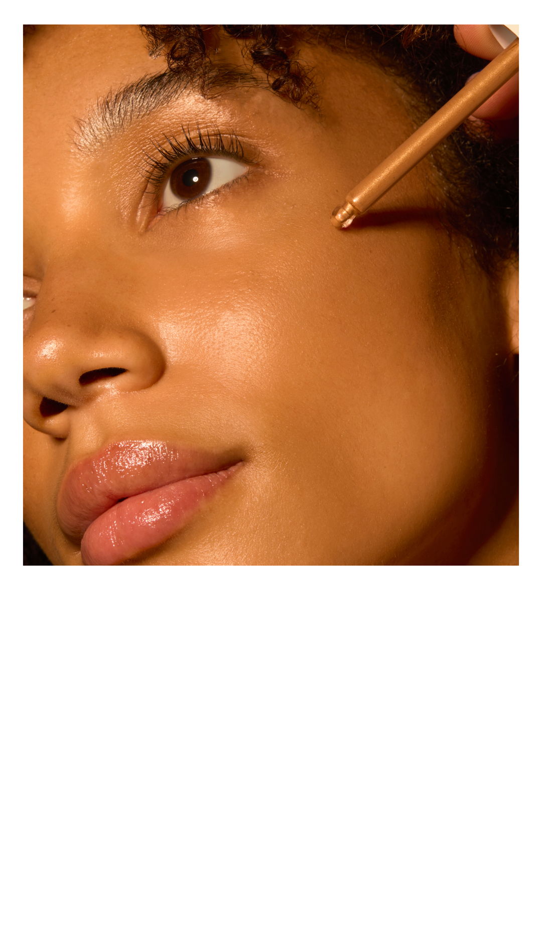 Close-up of a person applying makeup on their cheek.