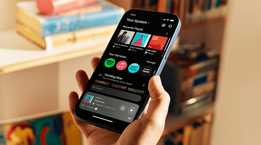 A person holding a smartphone displaying a music streaming app.