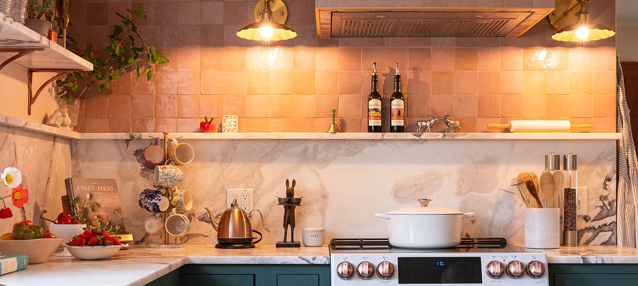 Kitchen counter with mood lighting from sconces over range. 