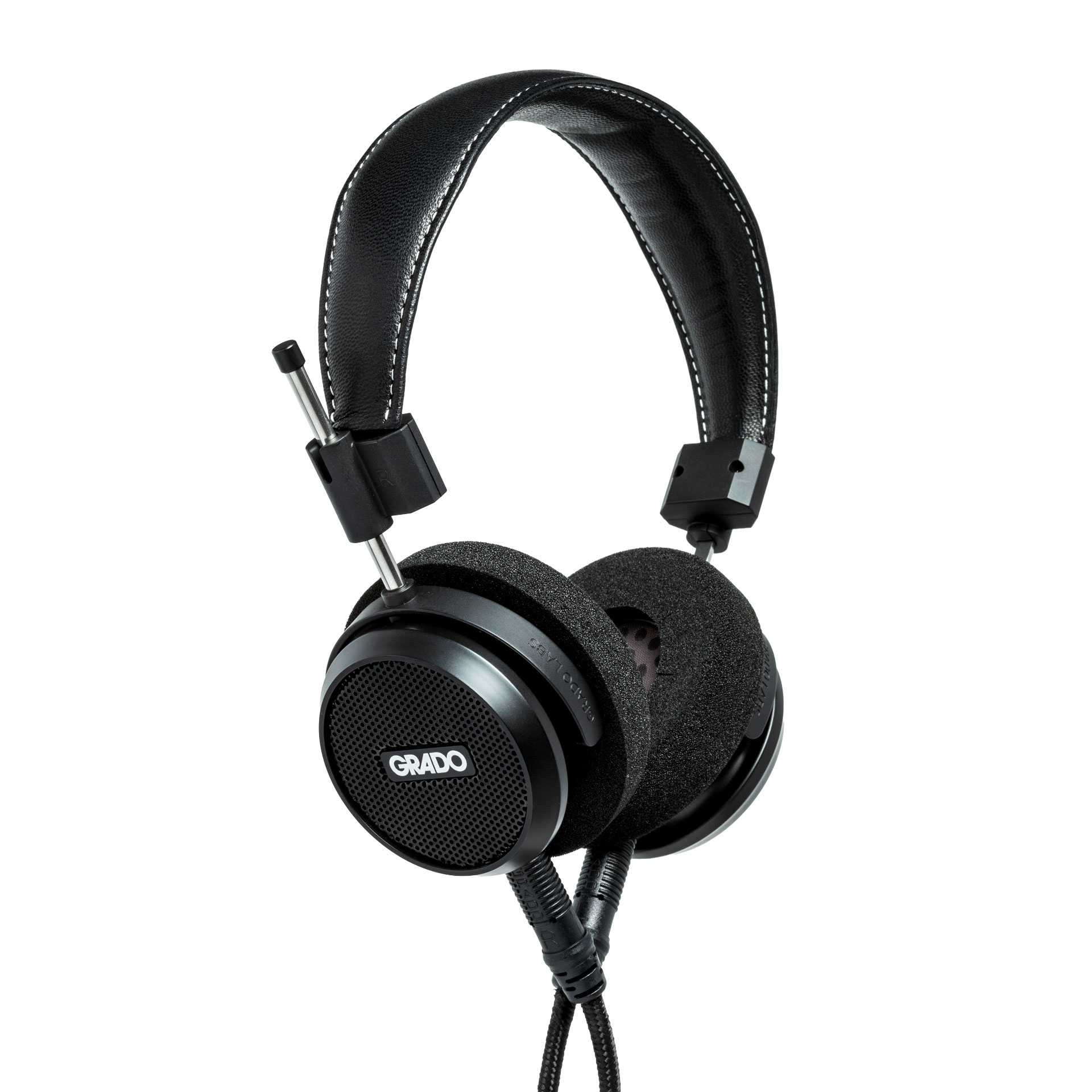 Photo of Grado S150 Headphones taken from the 3/4 view - the Grado logo is featured in the center of the ear cup and the black cables can be seen coming out of the headphone.