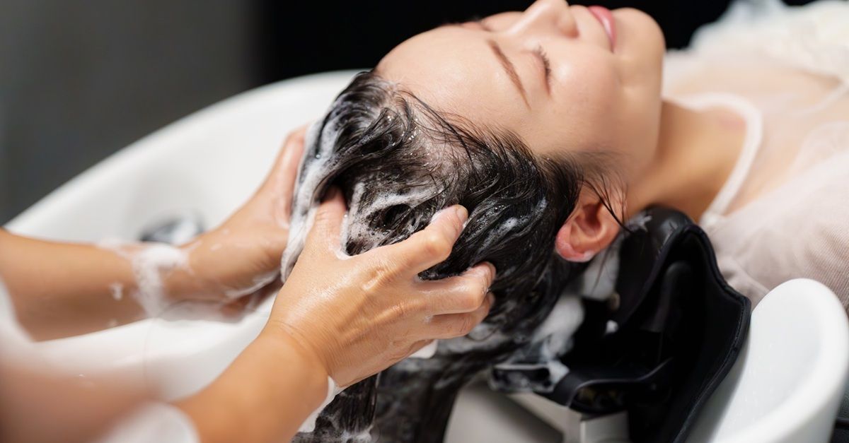 A woman receiving a hair wash at a salon.