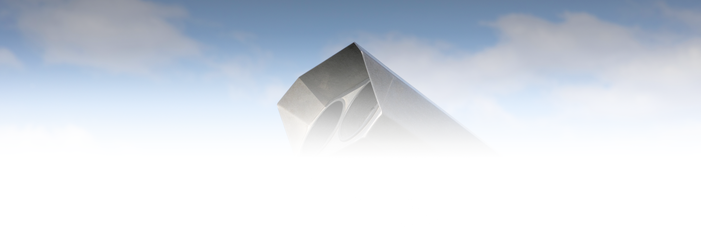 A pyramid-shaped structure emerging from foggy clouds.