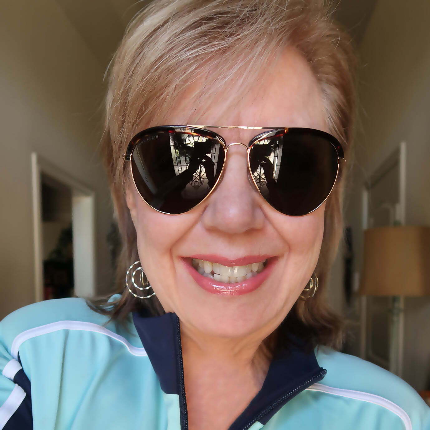 NativePath female customer with blonde hair and sunglasses smiling into camera