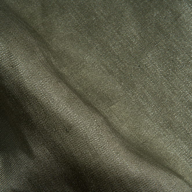 Textured green fabric with soft folds and natural light.