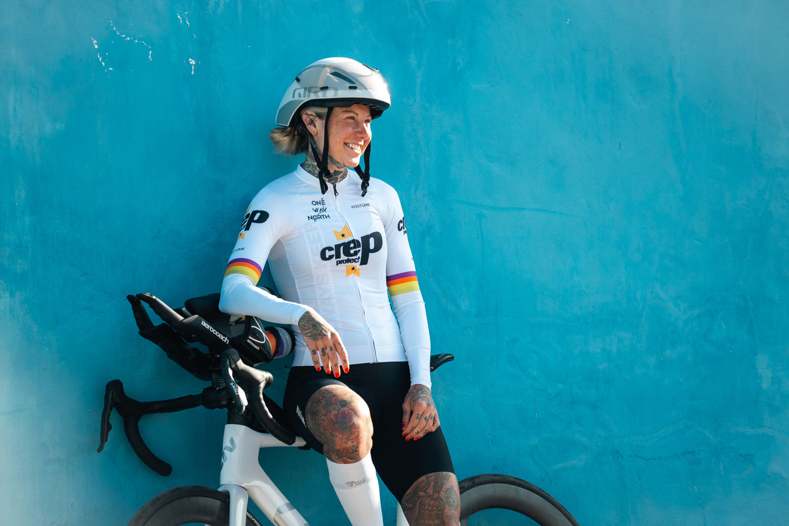 Dr. Sarah Ruggins leans on a wall in Tarifa wearing the final Kostüme kit for One Way North