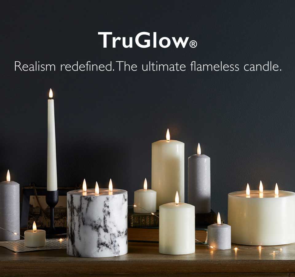 Selection of TruGlow® indoor candles flickering on a sideboard