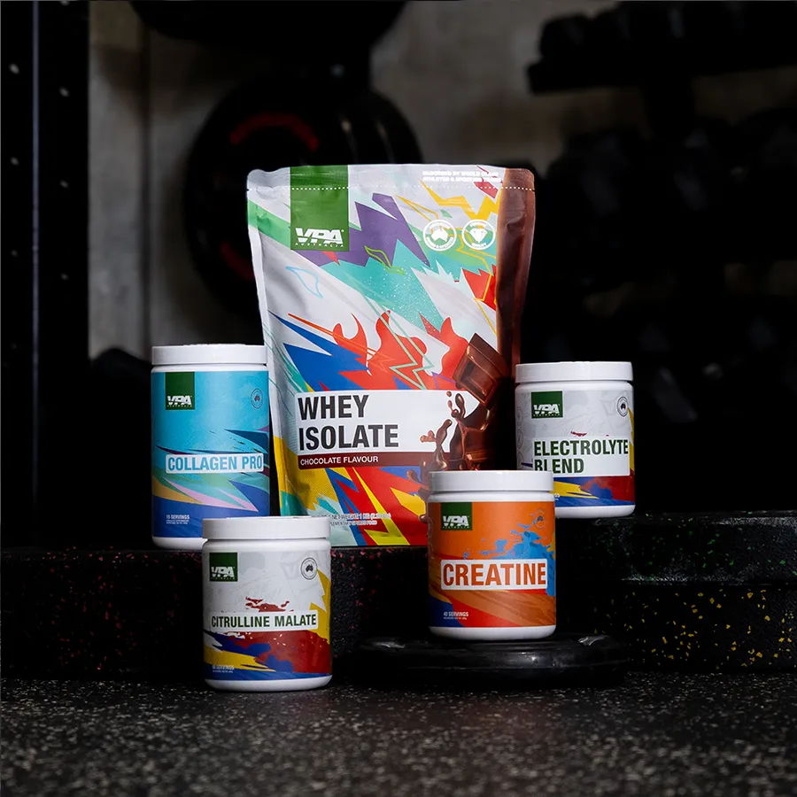 Various fitness supplement containers arranged on a gym floor.