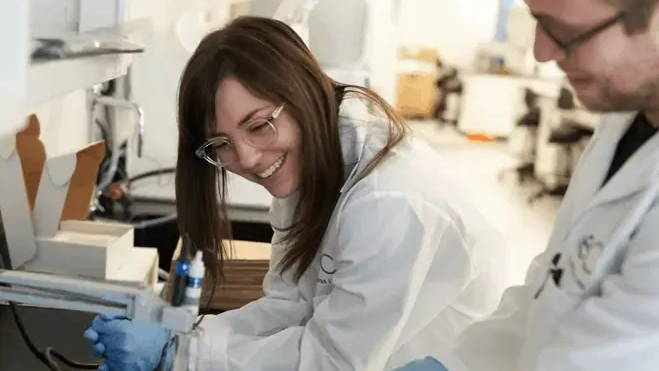 Jalene leans on counter in lab