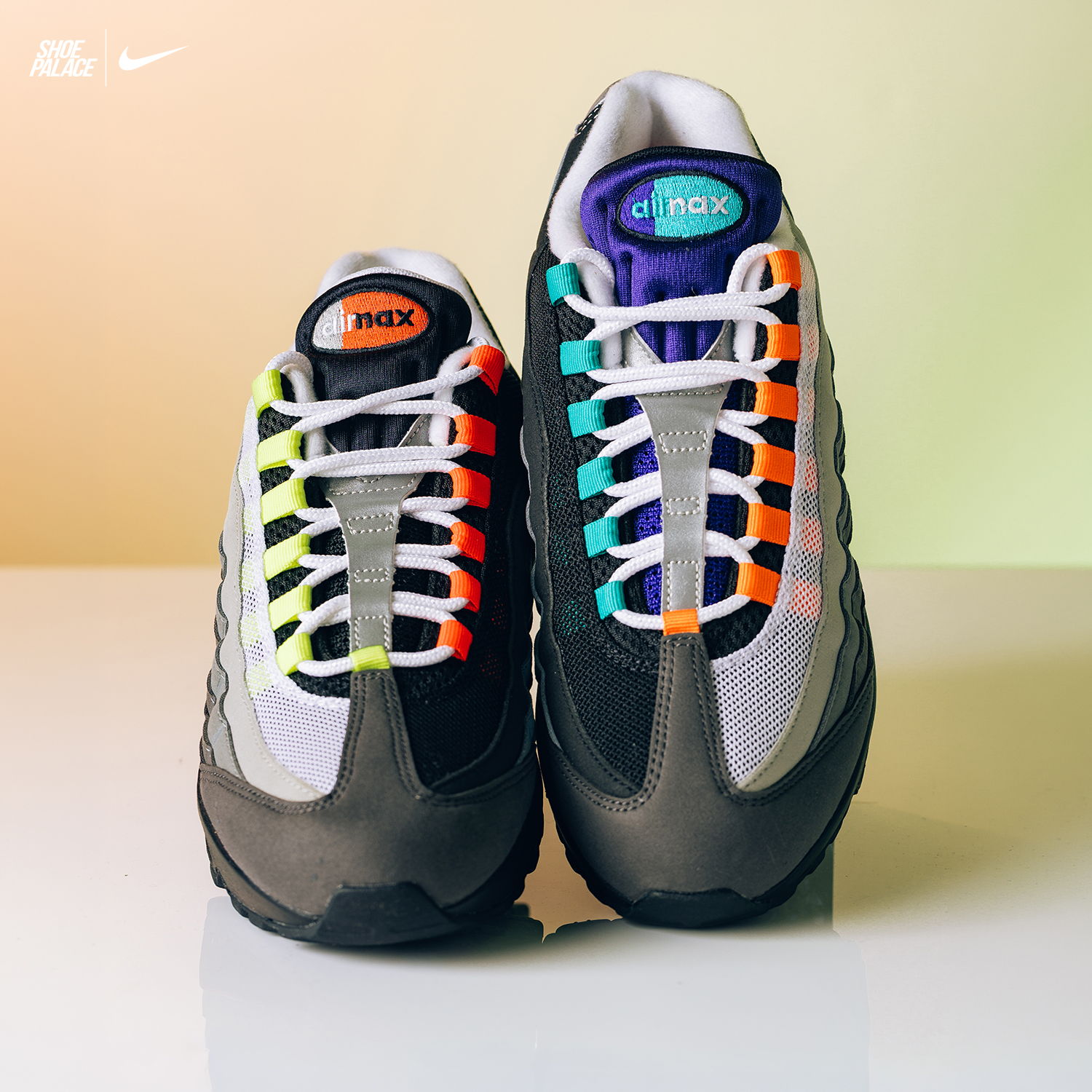 A pair of Nike Air Max 95 sneakers with colorful laces.