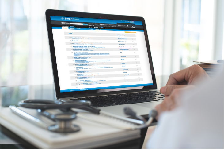 Doctor viewing ADAM SmartCare information on laptop